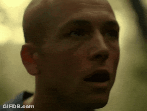 A Close Up Of A Bald Man 'S Face With His Mouth Open GIF
