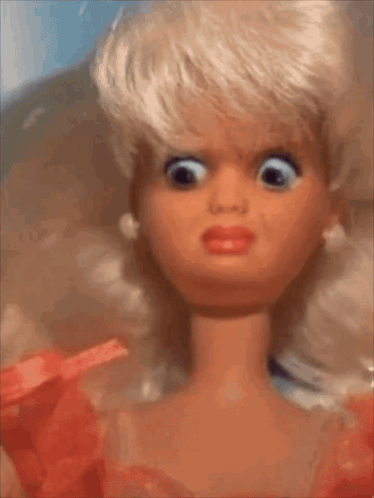 A Close Up Of A Barbie Doll Making A Face GIF