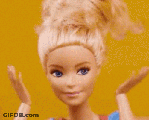 A Close Up Of A Barbie Doll 'S Face With Her Hands Up . GIF