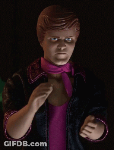 A Close Up Of A Barbie Doll With A Pink Scarf Around His Neck GIF