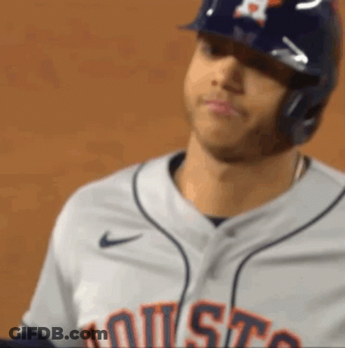 A Close Up Of A Baseball Player Wearing A Helmet And A Jersey That Says Houston GIF