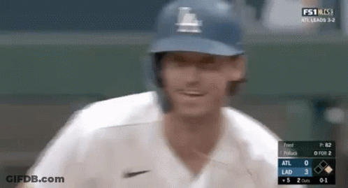 A Close Up Of A Baseball Player Wearing A Helmet And A White Jersey . GIF