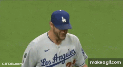 A Close Up Of A Baseball Player Wearing A La Hat On A Baseball Field . GIF