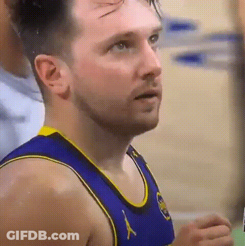 A Close Up Of A Basketball Player Wearing A Blue And Yellow Uniform . GIF