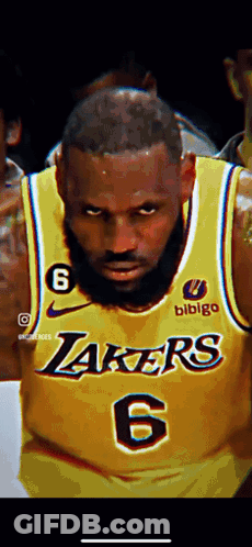 A Close Up Of A Basketball Player Wearing A Yellow Lakers Jersey . GIF