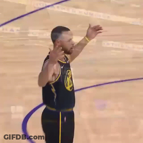 A Close Up Of A Basketball Player With His Fist In The Air . GIF