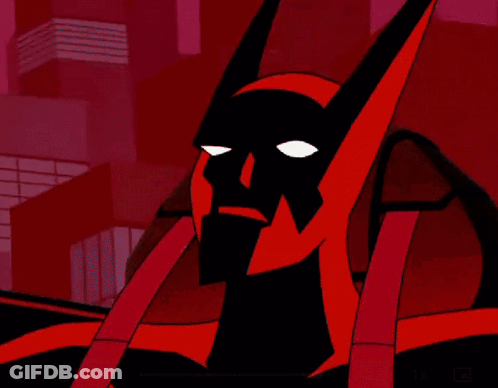 A Close Up Of A Batman Cartoon Character With A Red Background And Buildings In The Background . GIF