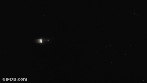 A Close Up Of A Batman Logo In The Dark . GIF