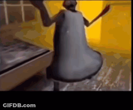A Close Up Of A Bell With A Person Standing Behind It GIF