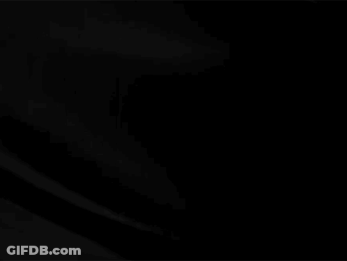 A Close Up Of A Black Cloth Moving In The Wind On A Black Background . GIF
