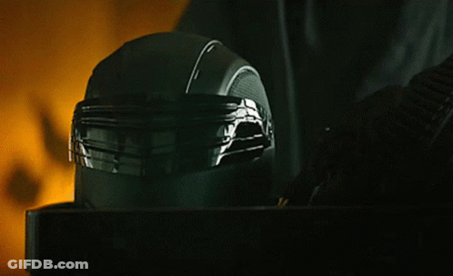 A Close Up Of A Black Helmet On A Table With A Yellow Background GIF