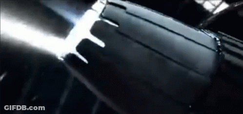 A Close Up Of A Black Object In A Dark Room With A Light Coming Out Of It . GIF