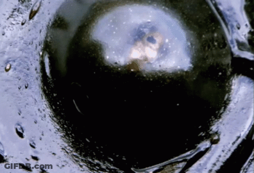 A Close Up Of A Black Sphere With A White Circle In The Middle GIF