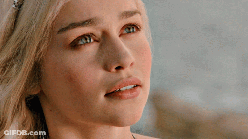 A Close Up Of A Blonde Woman 'S Face With Blue Eyes GIF
