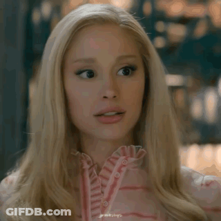 A Close Up Of A Blonde Woman Wearing A Pink Shirt GIF