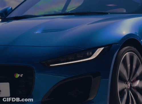 A Close Up Of A Blue Car With The Letter R On It GIF