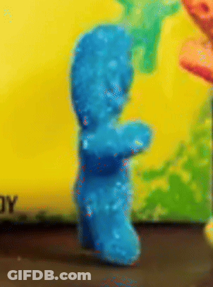 A Close Up Of A Blue Gummy Bear With A Yellow Background GIF