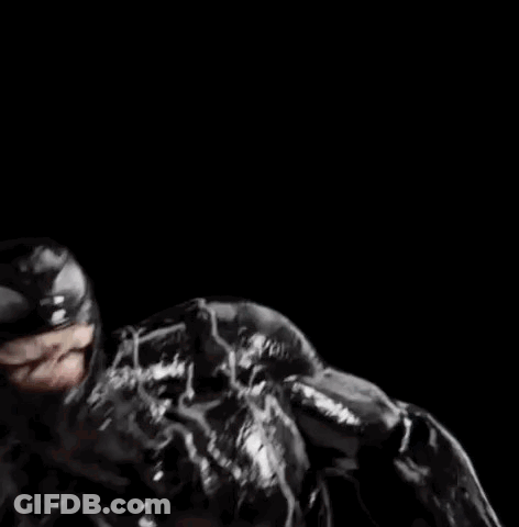 A Close Up Of A Bottle Of Milk Being Poured Into A Glass On A Black Background . GIF