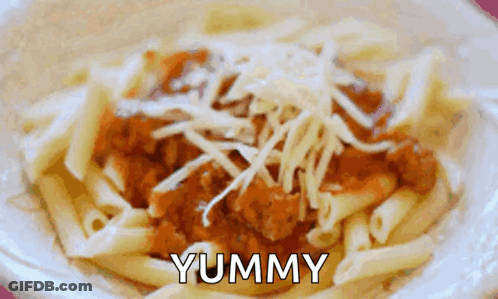A Close Up Of A Bowl Of Pasta With The Word Yummy Written On It GIF