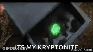 A Close Up Of A Box With A Green Glowing Object In It And The Words `` It 'S My Kryptonite '' . GIF