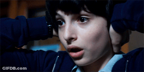 A Close Up Of A Boy Covering His Ears With His Hands GIF