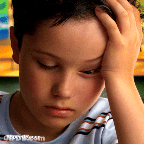 A Close Up Of A Boy 'S Face With The Hashtag #Speedracer On The Bottom GIF