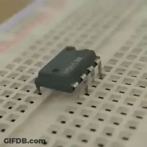 A Close Up Of A Breadboard With A Chip On It . GIF