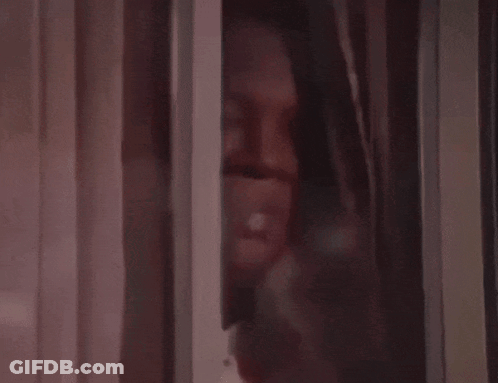 A Close Up Of A Brown Curtain With A White Stripe GIF