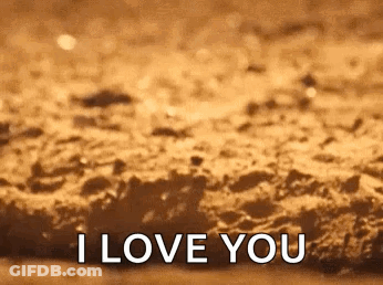 A Close Up Of A Brown Surface With The Words `` I Love You '' On It . GIF