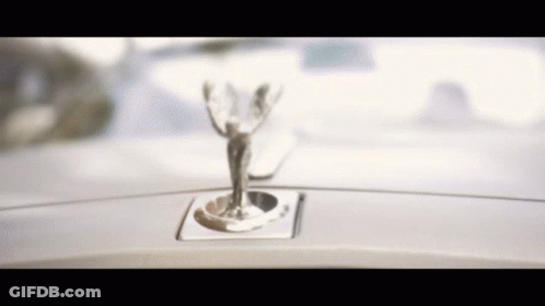 A Close Up Of A Car Emblem That Looks Like A Statue GIF