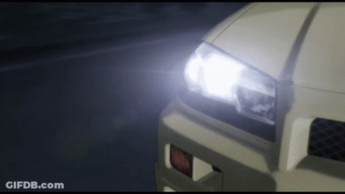 A Close Up Of A Car 'S Headlight With A Glowing Light GIF