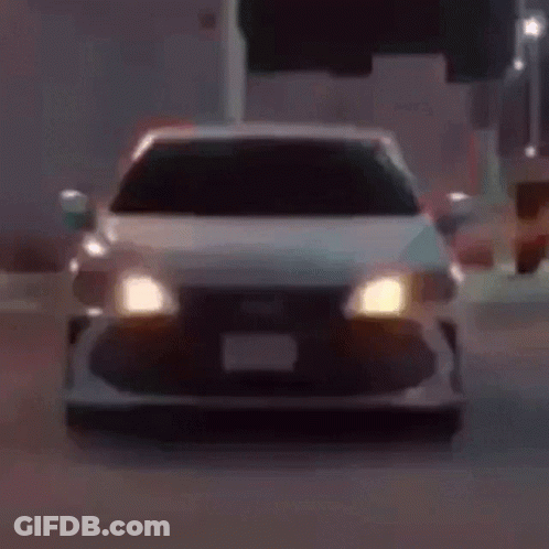 A Close Up Of A Car 'S Headlights Glowing In The Dark GIF
