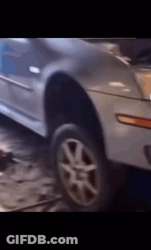 A Close Up Of A Car With A Tire On It GIF