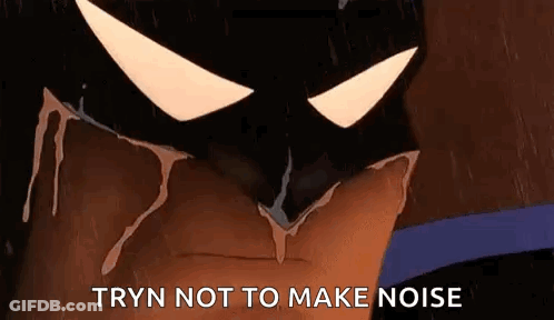 A Close Up Of A Cartoon Batman 'S Face With The Words `` Tryn Not To Make Noise '' Written On It . GIF