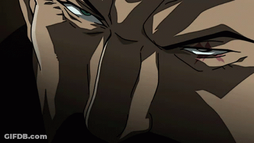 A Close Up Of A Cartoon Character 'S Eye With A Red Triangle In The Middle GIF
