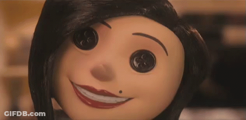 A Close Up Of A Cartoon Character 'S Face With Buttons On It 'S Eyes . GIF