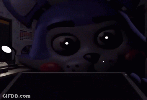 A Close Up Of A Cartoon Character 'S Face With Glowing Eyes And Teeth . GIF