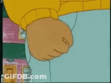 A Close Up Of A Cartoon Character 'S Fist With A Yellow Sweater On GIF