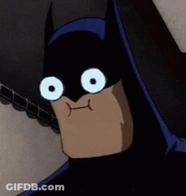 A Close Up Of A Cartoon Character Wearing A Batman Mask With Big White Eyes . GIF