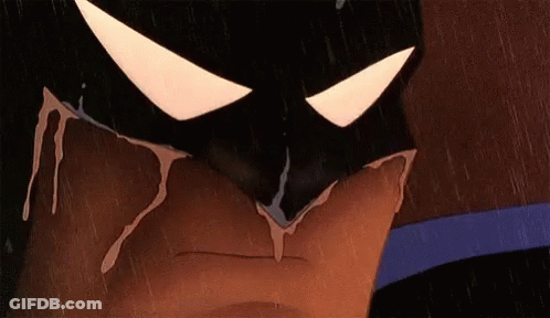 A Close Up Of A Cartoon Character Wearing A Batman Mask With Blood Dripping From It . GIF