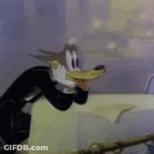 A Close Up Of A Cartoon Character Wearing A Tuxedo And A Hat . GIF