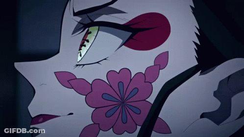 A Close Up Of A Cartoon Character With A Flower On Her Face GIF
