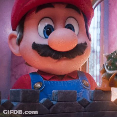 A Close Up Of A Cartoon Character With A Red Hat And Blue Overalls GIF