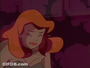 A Close Up Of A Cartoon Character With Red Hair And A Green Dress . GIF