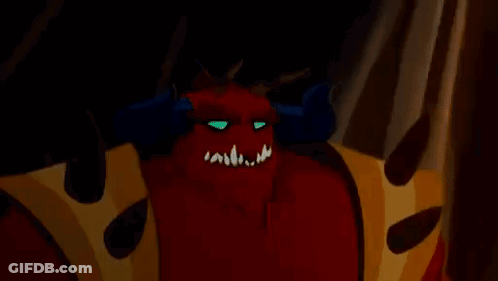 A Close Up Of A Cartoon Demon With Horns And A Crown On His Chest . GIF