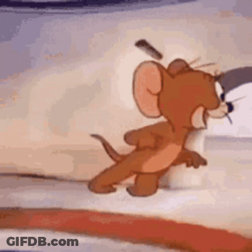 A Close Up Of A Cartoon Mouse Standing Next To A Bed . GIF