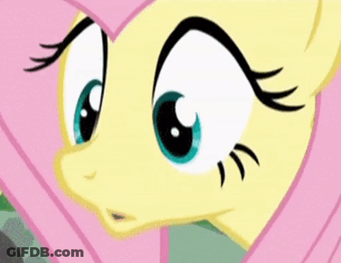 A Close Up Of A Cartoon Pony 'S Face With Big Blue Eyes And Black Eyelashes . GIF