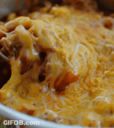 A Close Up Of A Casserole Dish Filled With Cheese And Meat GIF