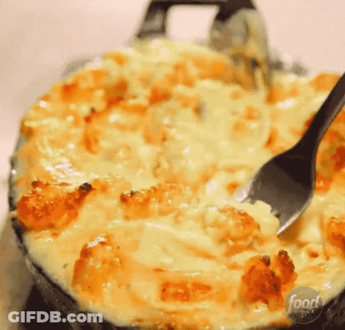 A Close Up Of A Casserole Dish With A Spoon In It And The Words Food Network On The Bottom GIF