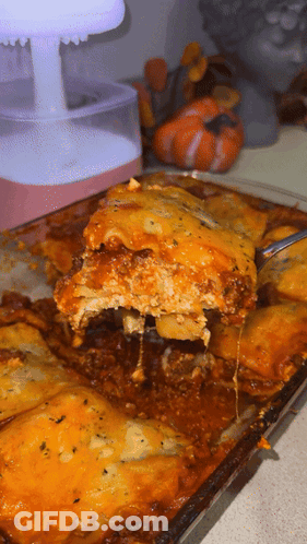 A Close Up Of A Casserole Dish With A Spoon In It GIF